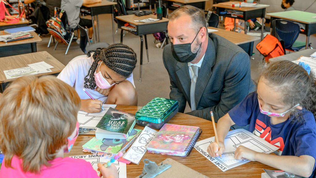 Photo of Aaron Woody with students