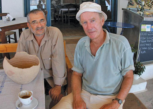 Two men sit with pottery