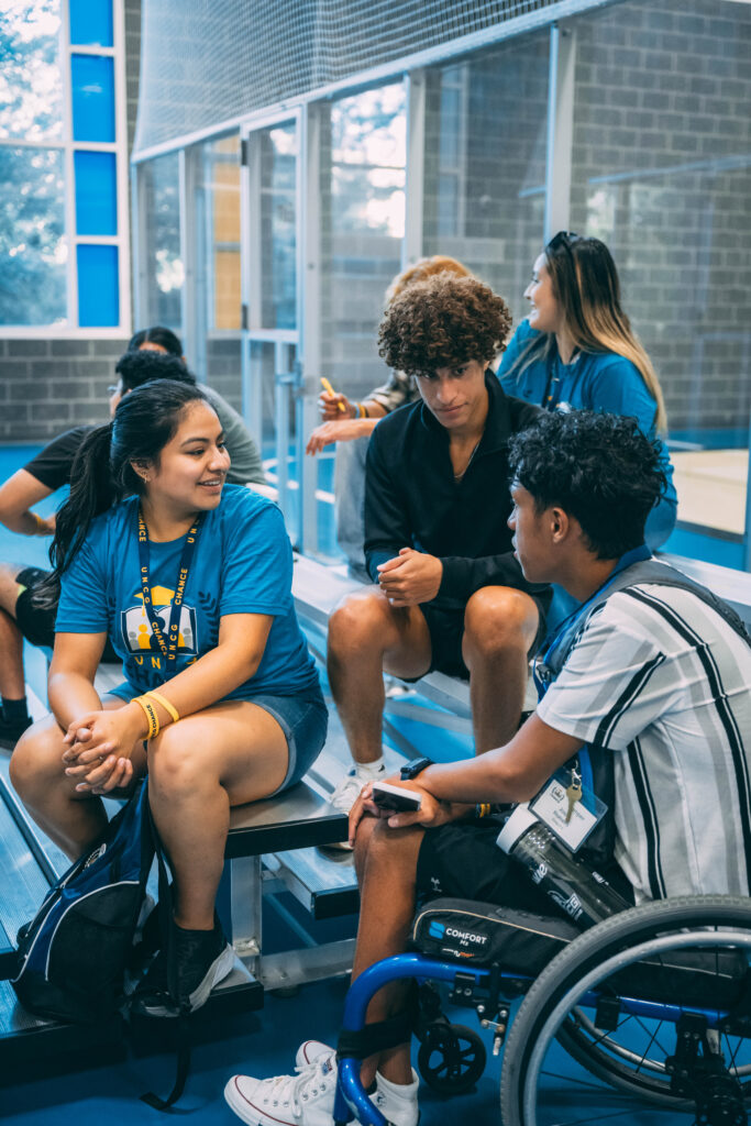 Three campers talk at a game night